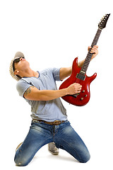 Image showing Attractive musician playing guitar