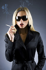 Image showing  blond woman holding a cigarette