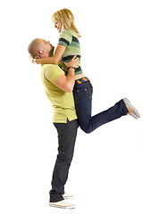 Image showing young man holding his girlfriend in the air