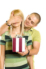 Image showing man surprising a woman with present