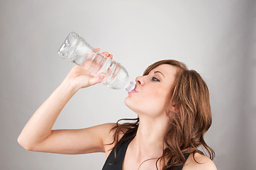 Image showing Beautiful young girl drinking water
