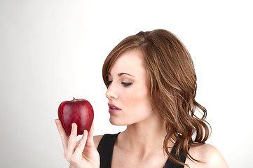 Image showing Beautiful girl examining an apple