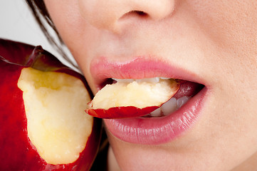 Image showing Girl's mouth biting apple