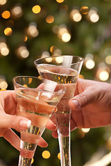 Image showing Man and Woman Toasting Champagne in Front of Lights