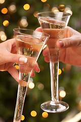 Image showing Man and Woman Toasting Champagne in Front of Lights