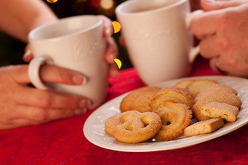 Image showing Man and Woman Sharing Hot Chocolate and Cookies