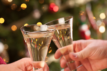 Image showing Man and Woman Toasting Champagne in Front of Lights