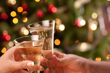 Image showing Man and Woman Toasting Champagne in Front of Lights