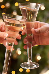 Image showing Man and Woman Toasting Champagne in Front of Lights