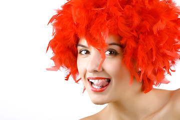 Image showing girl in red feathers with tongue ring exposed