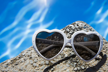 Image showing Heart Shaped Sunglasses by Pool