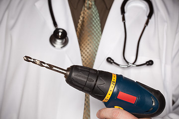 Image showing Doctor with Stethoscope Holding Big Drill