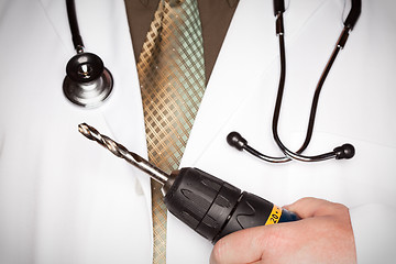 Image showing Doctor with Stethoscope Holding Big Drill