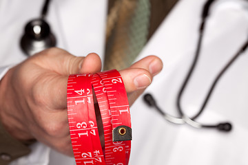 Image showing Doctor with Stethoscope Holding Measuring Tape