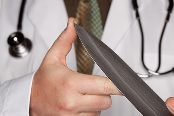 Image showing Doctor with Stethoscope Holding A Large Knife