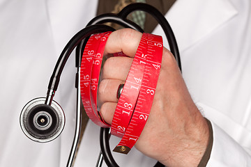 Image showing Doctor with Stethoscope Holding Measuring Tape