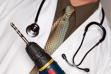 Image showing Doctor with Stethoscope Holding Big Drill