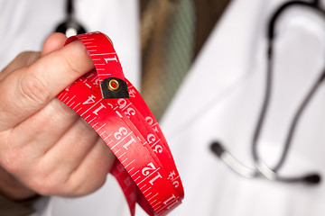 Image showing Doctor with Stethoscope Holding Measuring Tape
