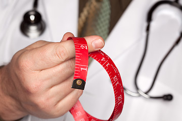 Image showing Doctor with Stethoscope Holding Measuring Tape