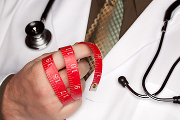 Image showing Doctor with Stethoscope Holding Measuring Tape