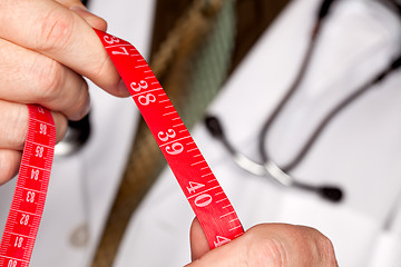 Image showing Doctor with Stethoscope Holding Measuring Tape