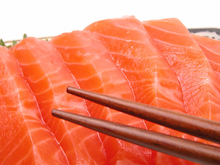 Image showing Chopsticks and salmon meat