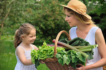 Image showing Young woman and daughter with fresh vegetable