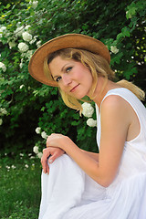 Image showing Young woman resting in garden