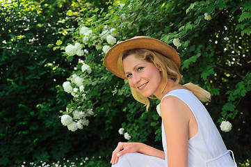 Image showing Young woman resting in garden