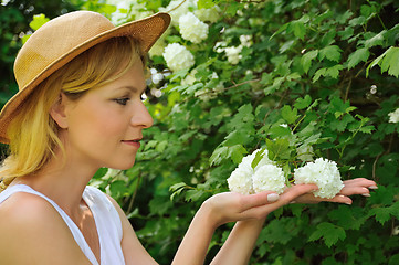 Image showing Young woman gardening - taking care of snowball