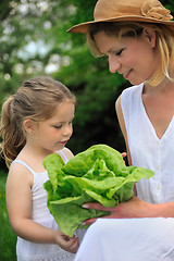 Image showing Young mother and daughter with lettuce