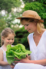 Image showing Young mother and daughter with lettuce