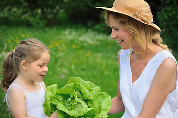 Image showing Young mother and daughter with lettuce