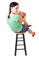 Image showing Pretty girl sitting on bar chair.