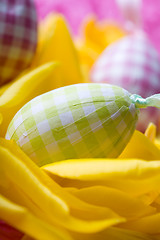 Image showing Easter eggs on yellow tulip petals