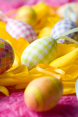 Image showing Easter eggs on yellow tulip petals