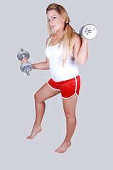 Image showing Blond hair woman with dumbbells.