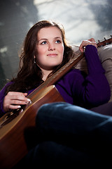 Image showing Beautiful teenager playing guitar