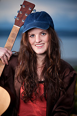 Image showing Beautiful teenager playing guitar