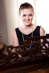 Image showing Beautiful teenager playing piano