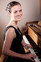 Image showing Beautiful teenager playing piano
