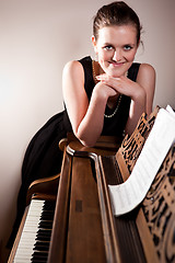 Image showing Beautiful teenager playing piano