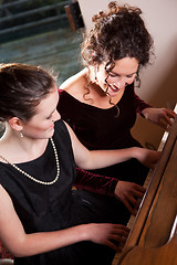 Image showing Mother and daughter playing piano