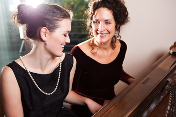 Image showing Mother and daughter playing piano