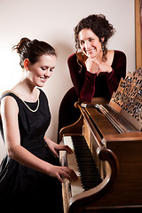 Image showing Mother and daughter playing piano