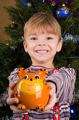 Image showing Boy with piggy bank