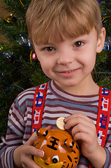 Image showing Boy with piggy bank