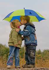 Image showing Little boy and girl with umbrella