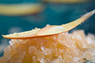 Image showing Bath salt with water droplets on flower petal