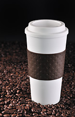 Image showing Commuter coffee cup on coffee beans.